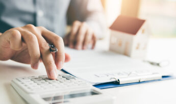 Home agents are using a calculator to calculate the loan period